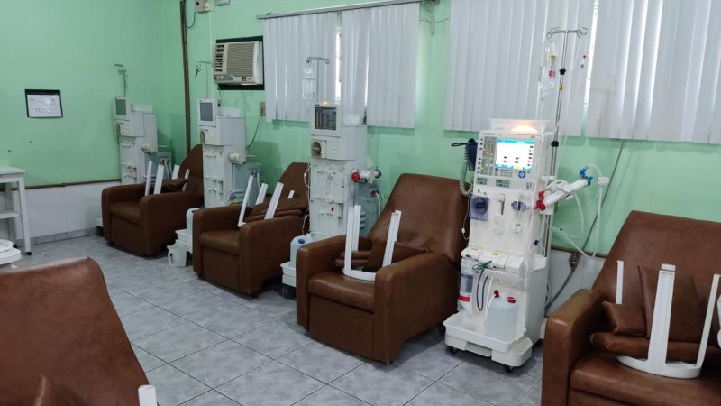 A imagem mostra várias cadeiras com os aparelhos de hemodiálise. 