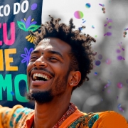 card com foto de close de um homem negro sorrindo com um estandarte escrito Bloco do Eu me Amo em letras coloridas, fundo com alguns confetes coloridos estilizados 